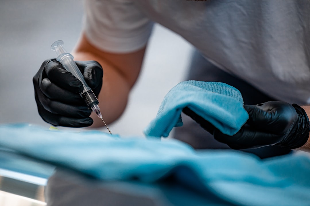 Car detaling with black plastic gloves and a needle injection.